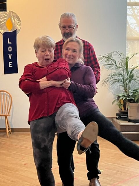 A choreography lesson with a man and a woman, with the choreographer between them
